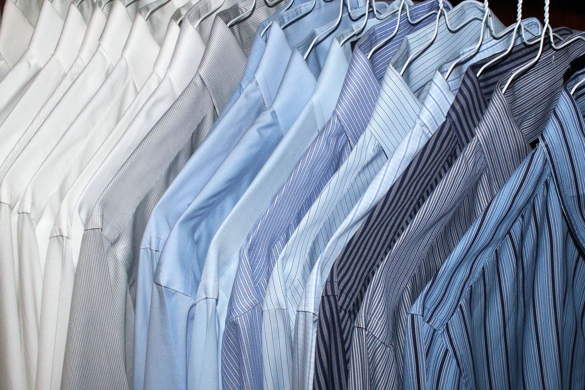 Dress shirts in shades of blue and white on hangers