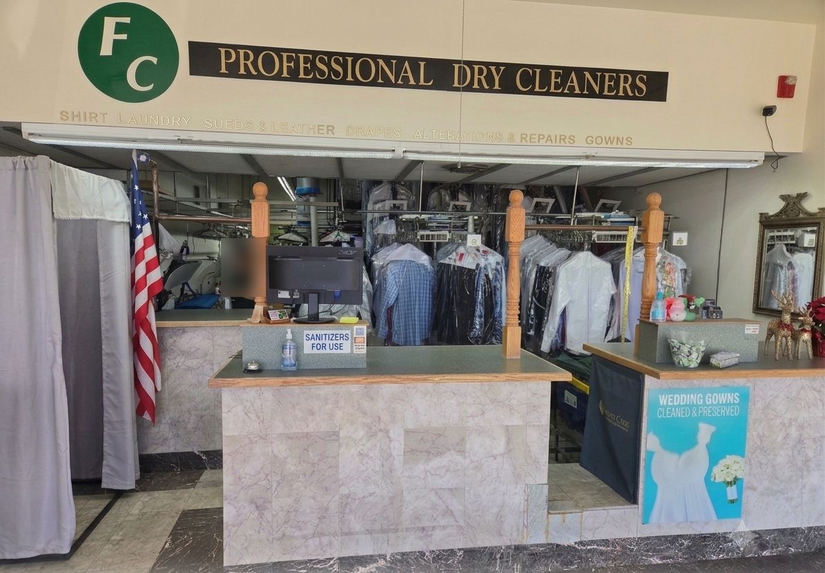 The FC PRO Dry Cleaners counter in Lone Tree, with the wedding gown preservation sign